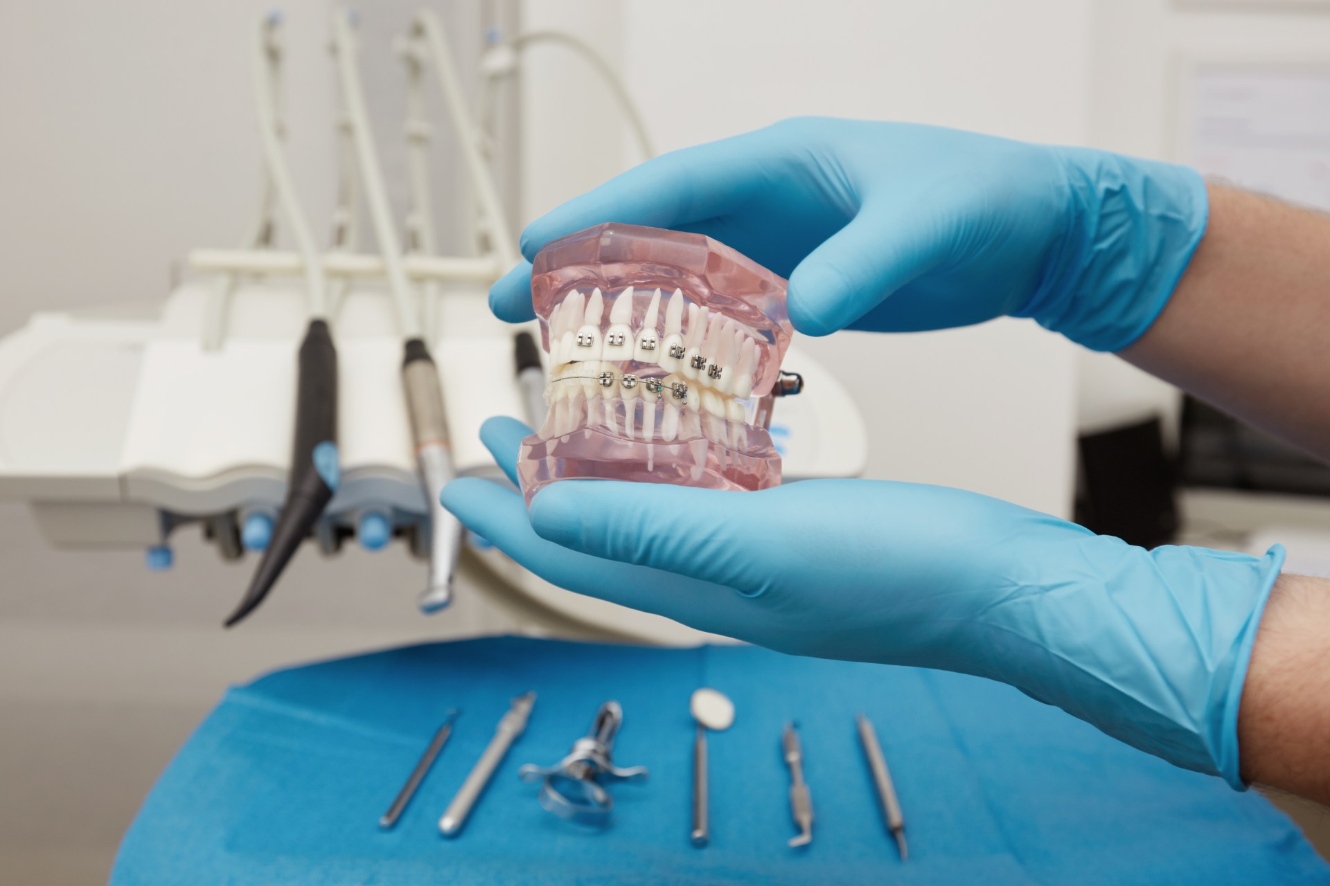 Dentist showing a woman a clear Invisalign aligner